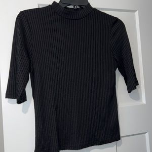 Black turtle neck with half sleeves. Classy black top. Can’t go wrong!!